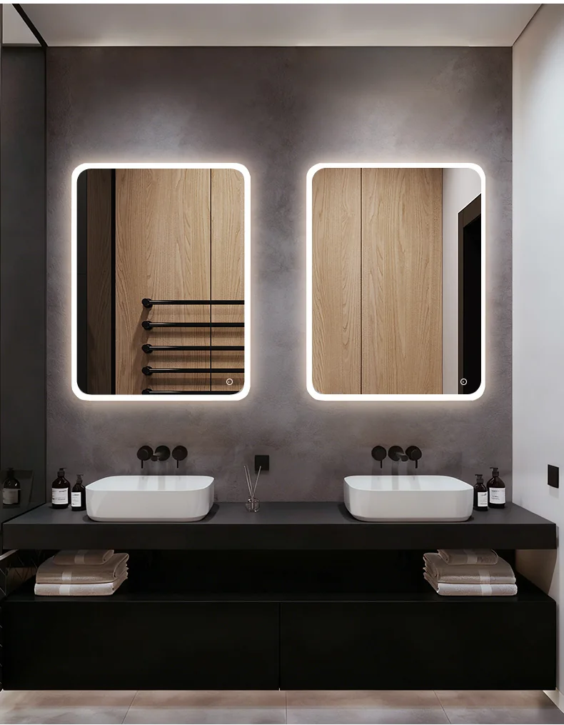 LED bathroom mirror installed in a hotel guest bathroom vanity area.