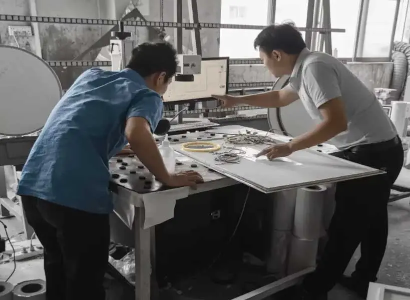 NewThingLine engineers performing precision testing on LED mirror prototypes