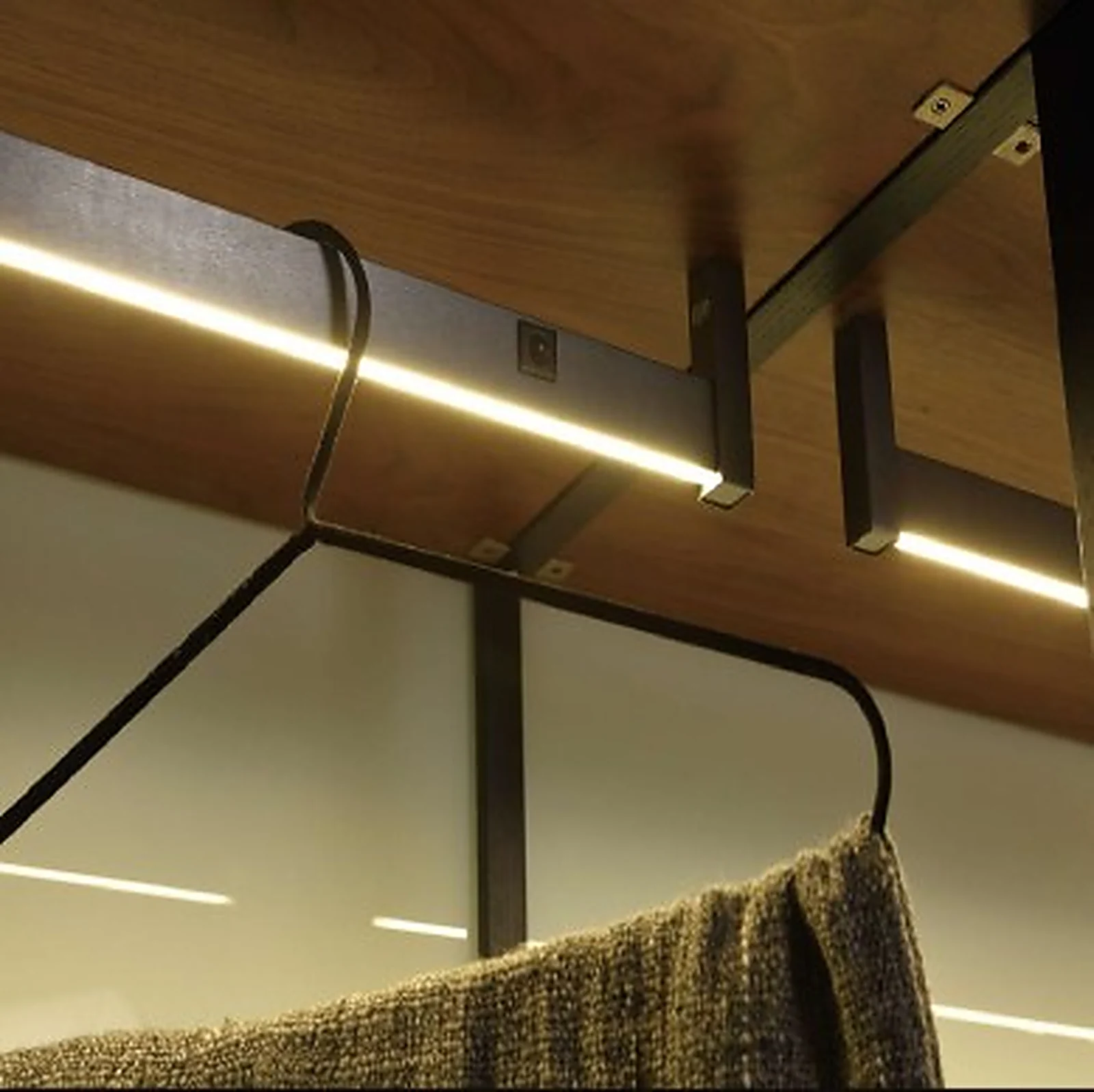 Lysstang wardrobe hanger LED profile lit inside a wardrobe, garment on the hanging rail