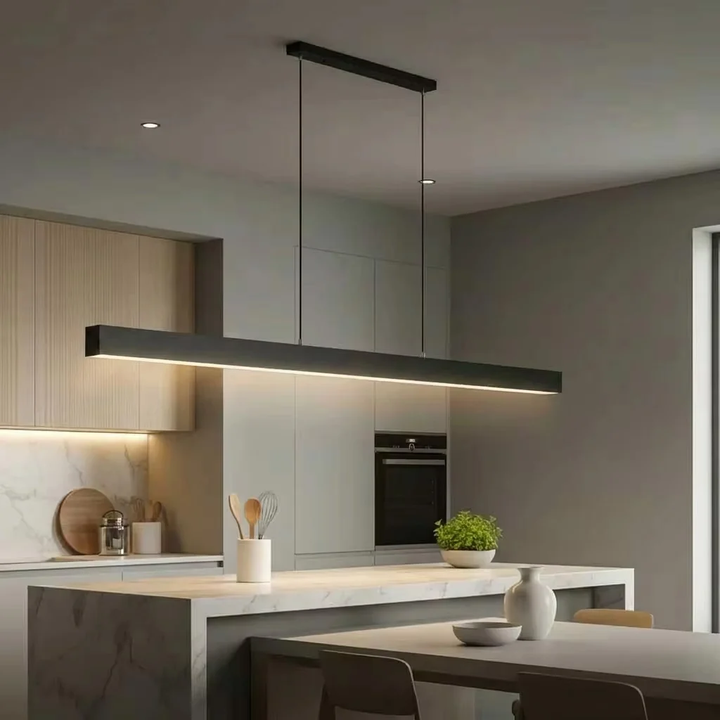 Matte black slender linear LED pendant light above a modern kitchen island