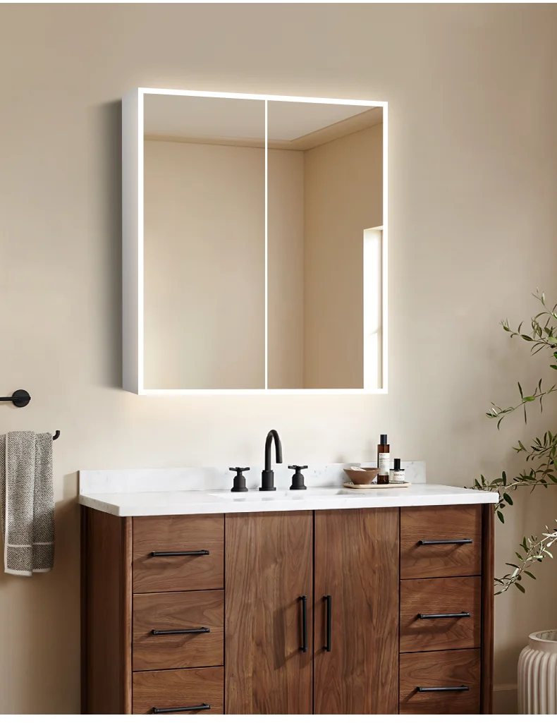 Illuminated mirror cabinet in bathroom furniture setting with integrated LED lighting.